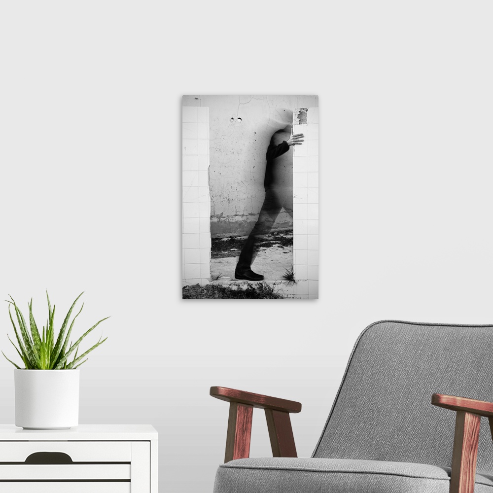 A modern room featuring Conceptual photograph of a male figure stepping through a wall.