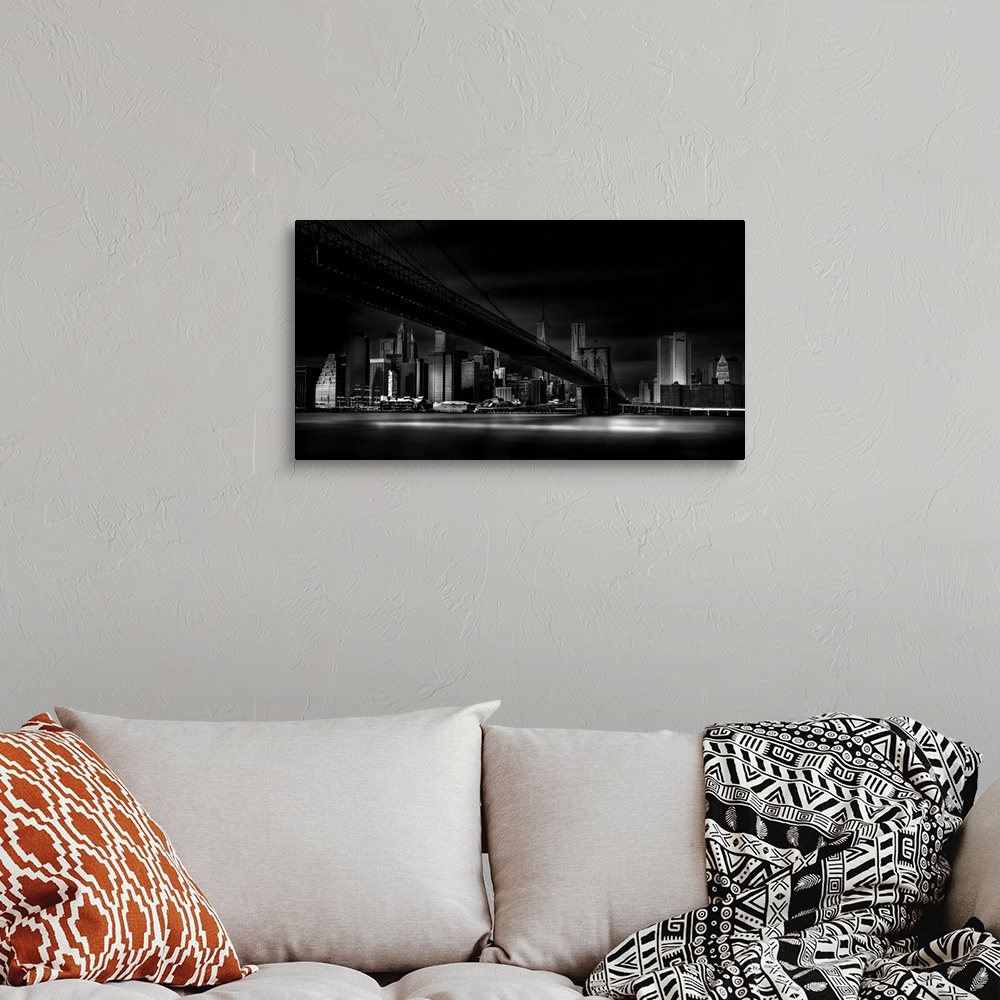 A bohemian room featuring A dramatic black and white photograph of the New York city skyline with the Brooklyn bridge in th...