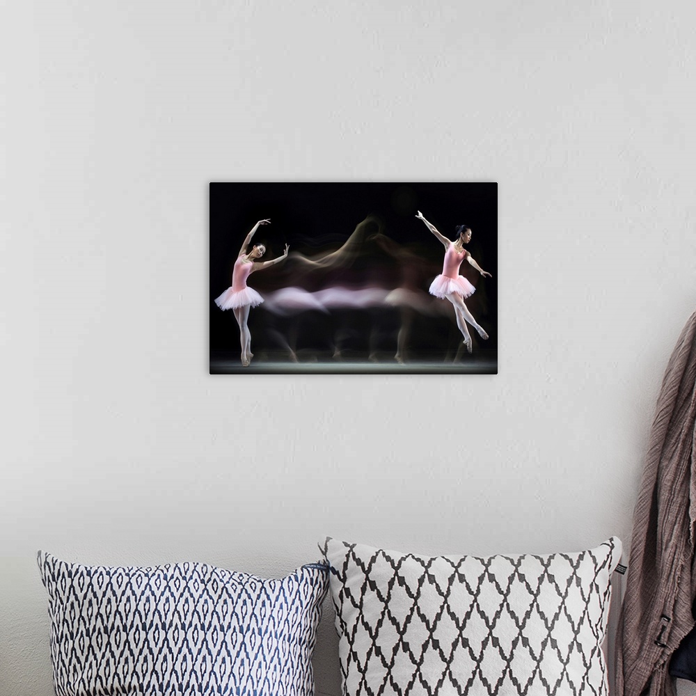 A bohemian room featuring Time-lapse image of a ballerina in a pink dress dancing across a stage.