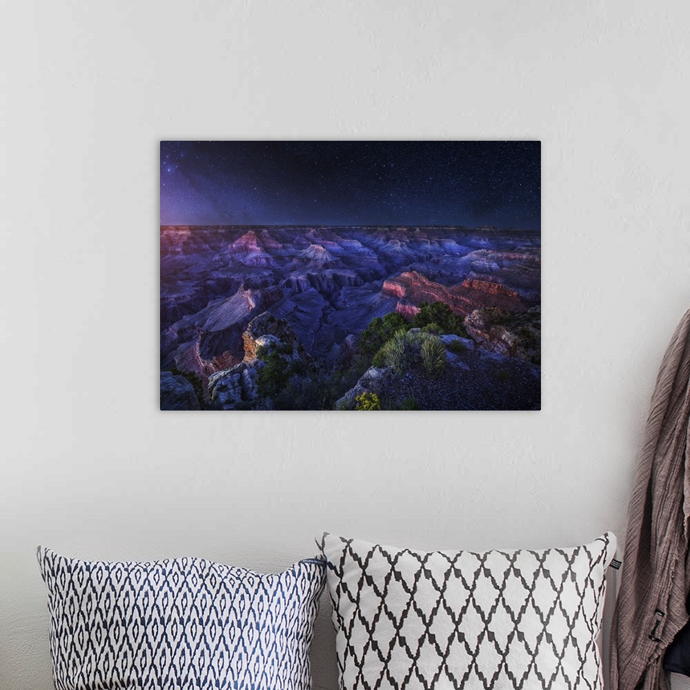 A bohemian room featuring An intense dramatic photograph of the Grand Canyon under night sky, with every star seen.