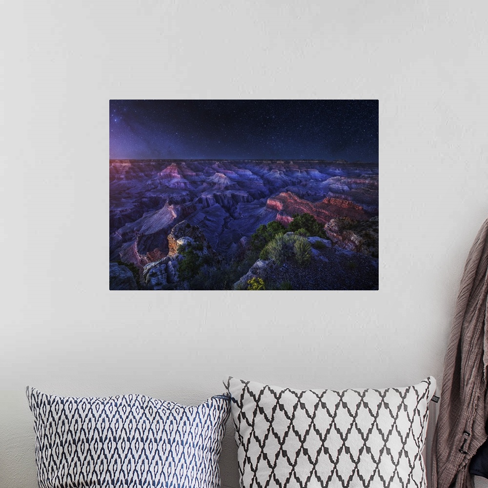 A bohemian room featuring An intense dramatic photograph of the Grand Canyon under night sky, with every star seen.