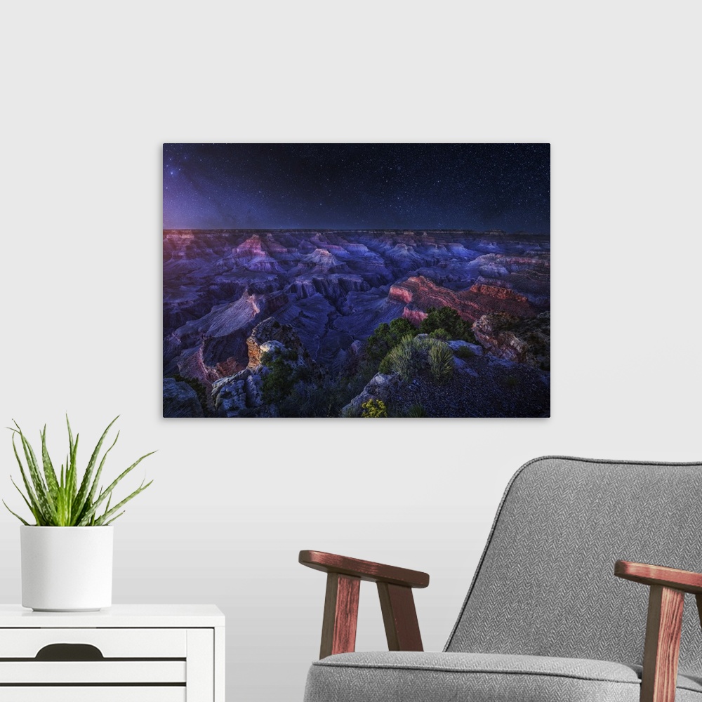 A modern room featuring An intense dramatic photograph of the Grand Canyon under night sky, with every star seen.