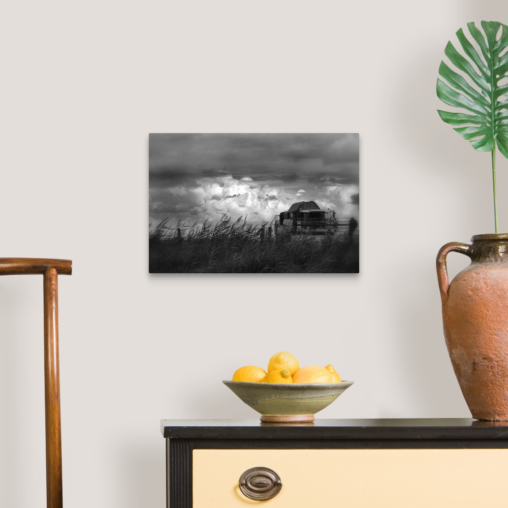 A traditional room featuring Farm equipment rolling through a field of wheat with a stormy sky full of clouds.