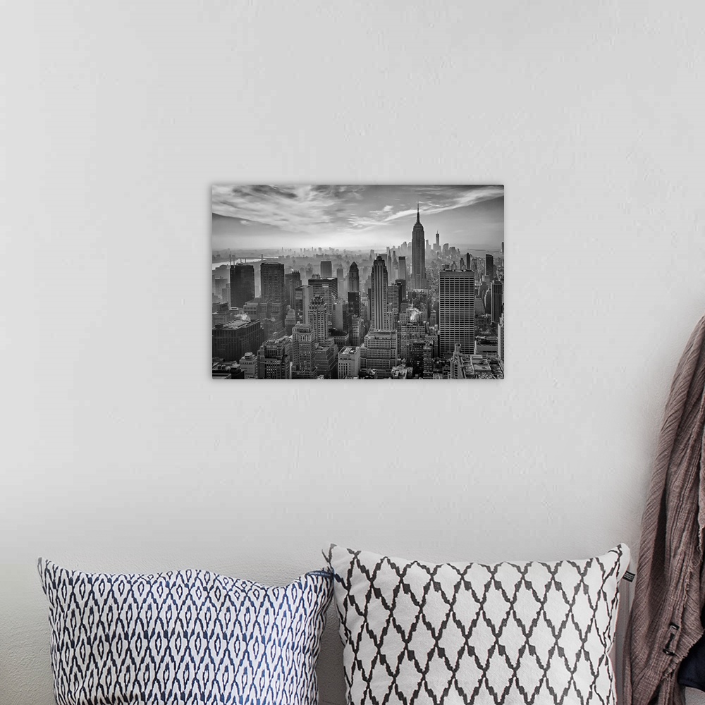 A bohemian room featuring A black and white photograph of the Empire state building standing tall in New York city.