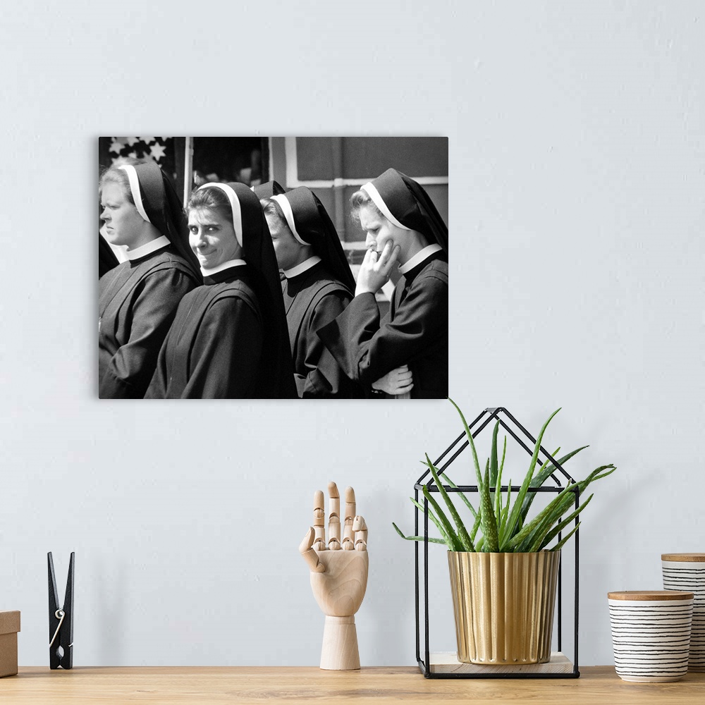 A bohemian room featuring A group of nuns walking in the street with one smiling, Poland.