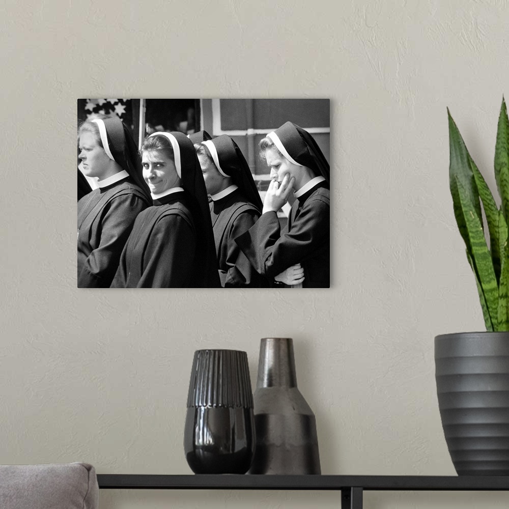 A modern room featuring A group of nuns walking in the street with one smiling, Poland.