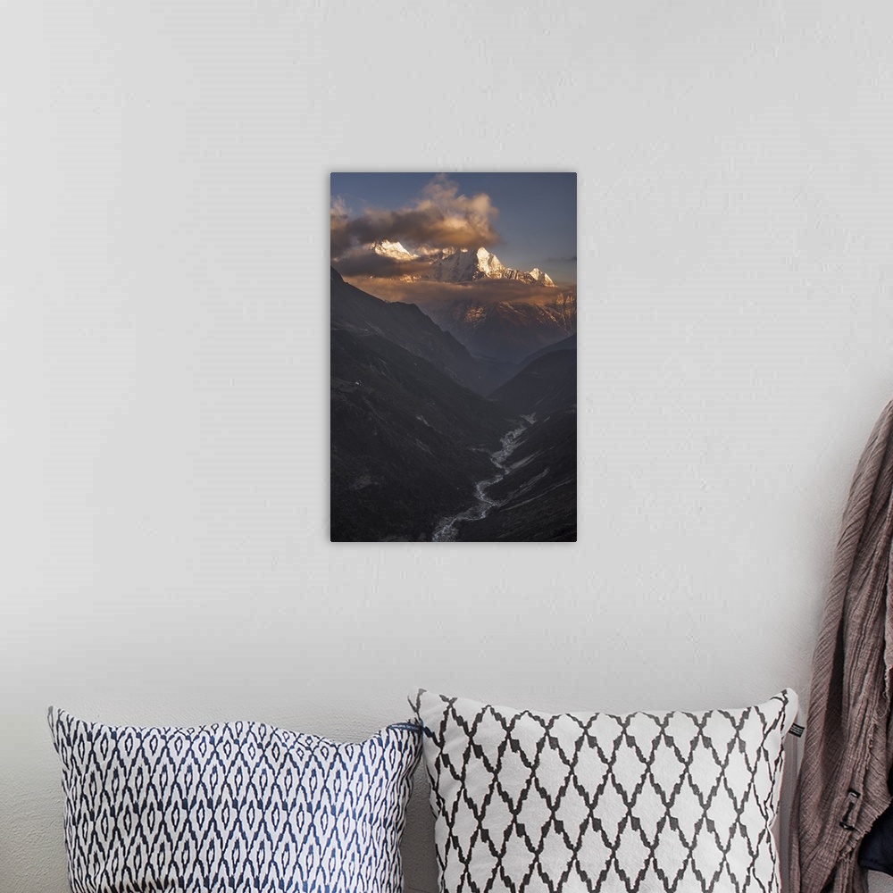 A bohemian room featuring A dynamic photograph of a mountain range above a deep valley.