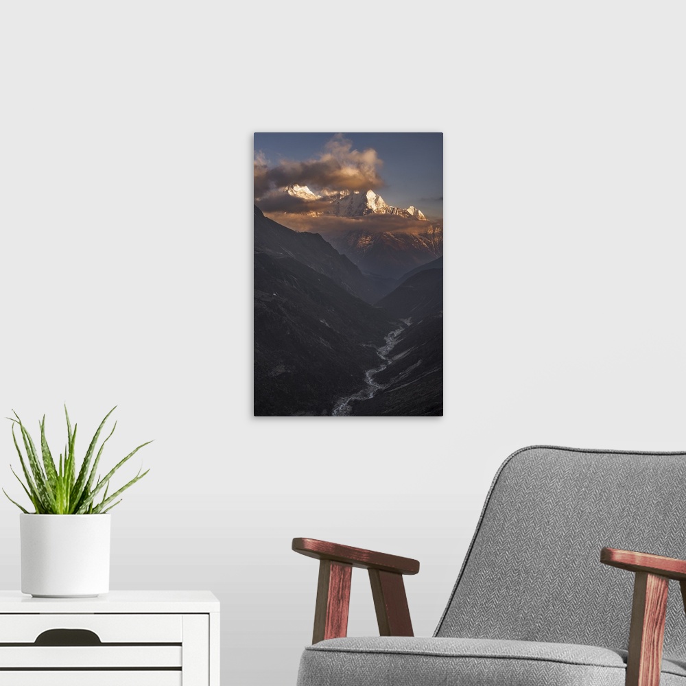 A modern room featuring A dynamic photograph of a mountain range above a deep valley.