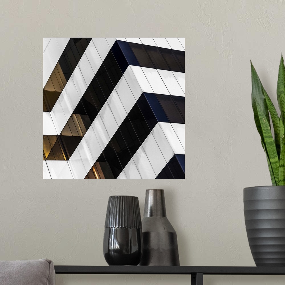 A modern room featuring Square fine art photograph of part of a black and white striped building facade.