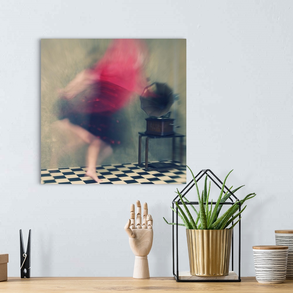 A bohemian room featuring Blurred motion image of a woman in red dancing to music from a phonograph.