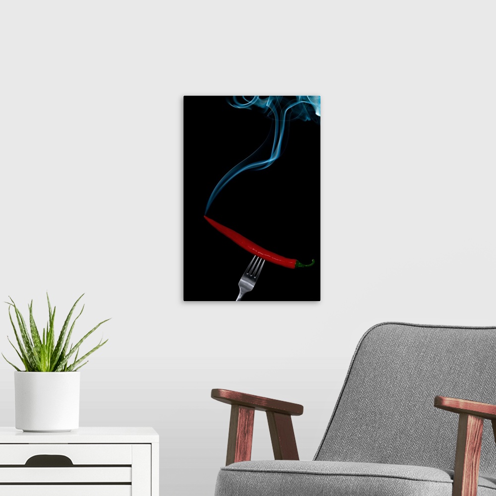 A modern room featuring Smoking hot chili pepper on fork on black background.