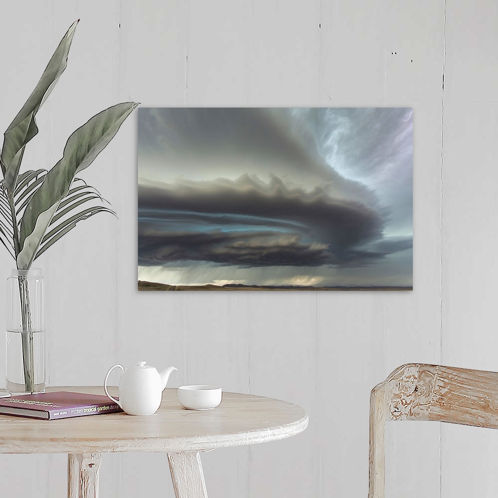 A farmhouse room featuring Large menacing storm clouds rolling over a countryside landscape.