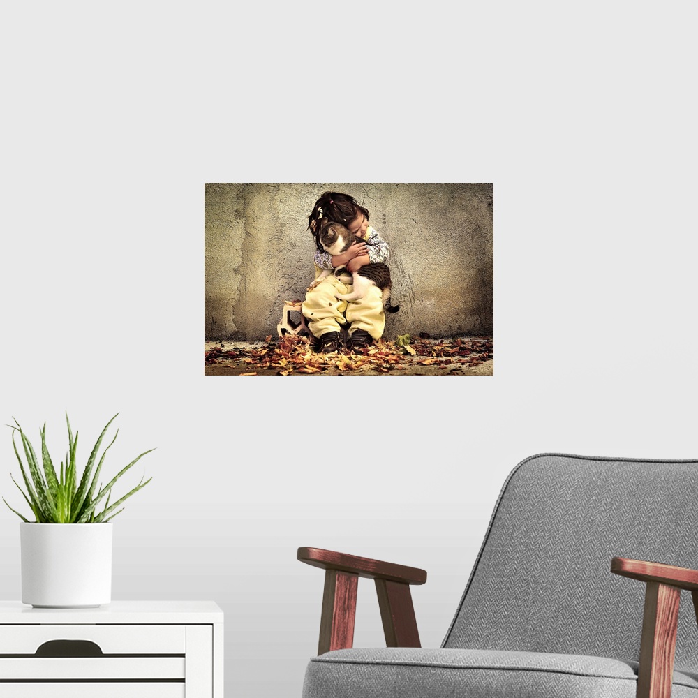 A modern room featuring A portrait of a little girl sitting against a wall and holding a cat in a loving embrace.