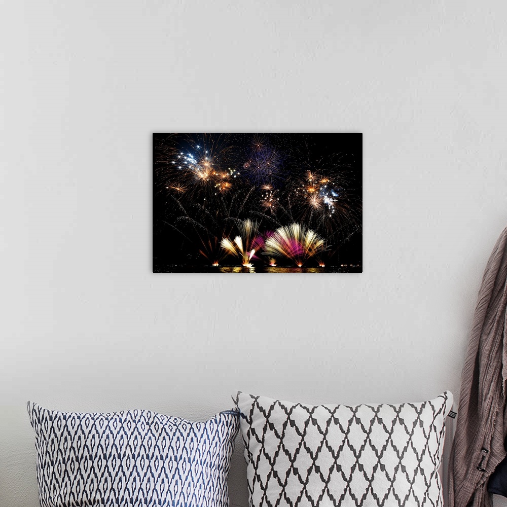 A bohemian room featuring Amazing fireworks display at night over Lecco, Italy.