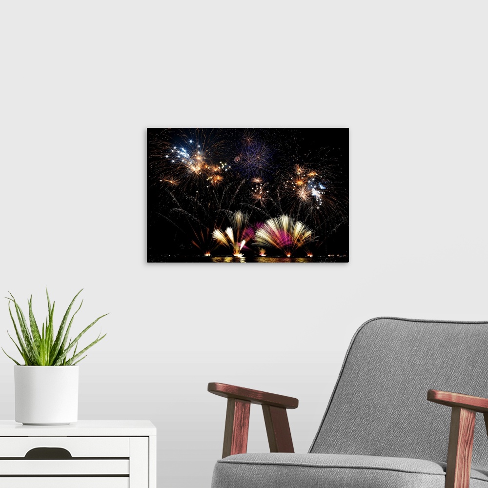 A modern room featuring Amazing fireworks display at night over Lecco, Italy.