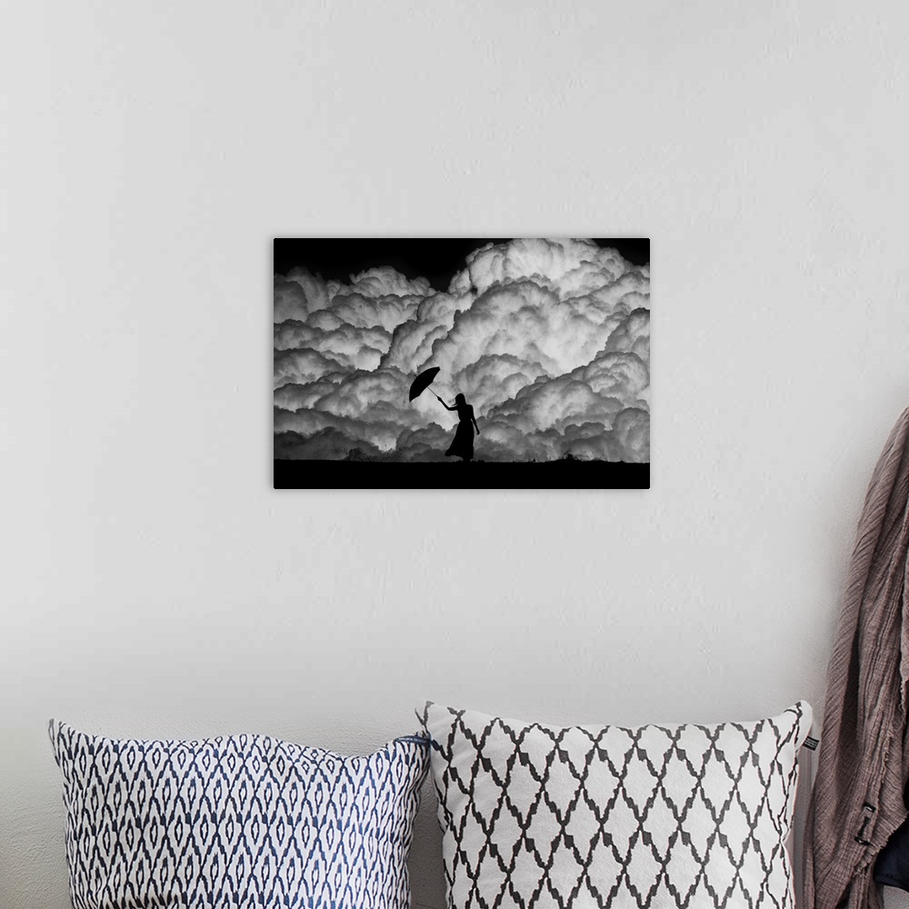 A bohemian room featuring Silhouette of a woman with an umbrella in front of huge storm clouds.