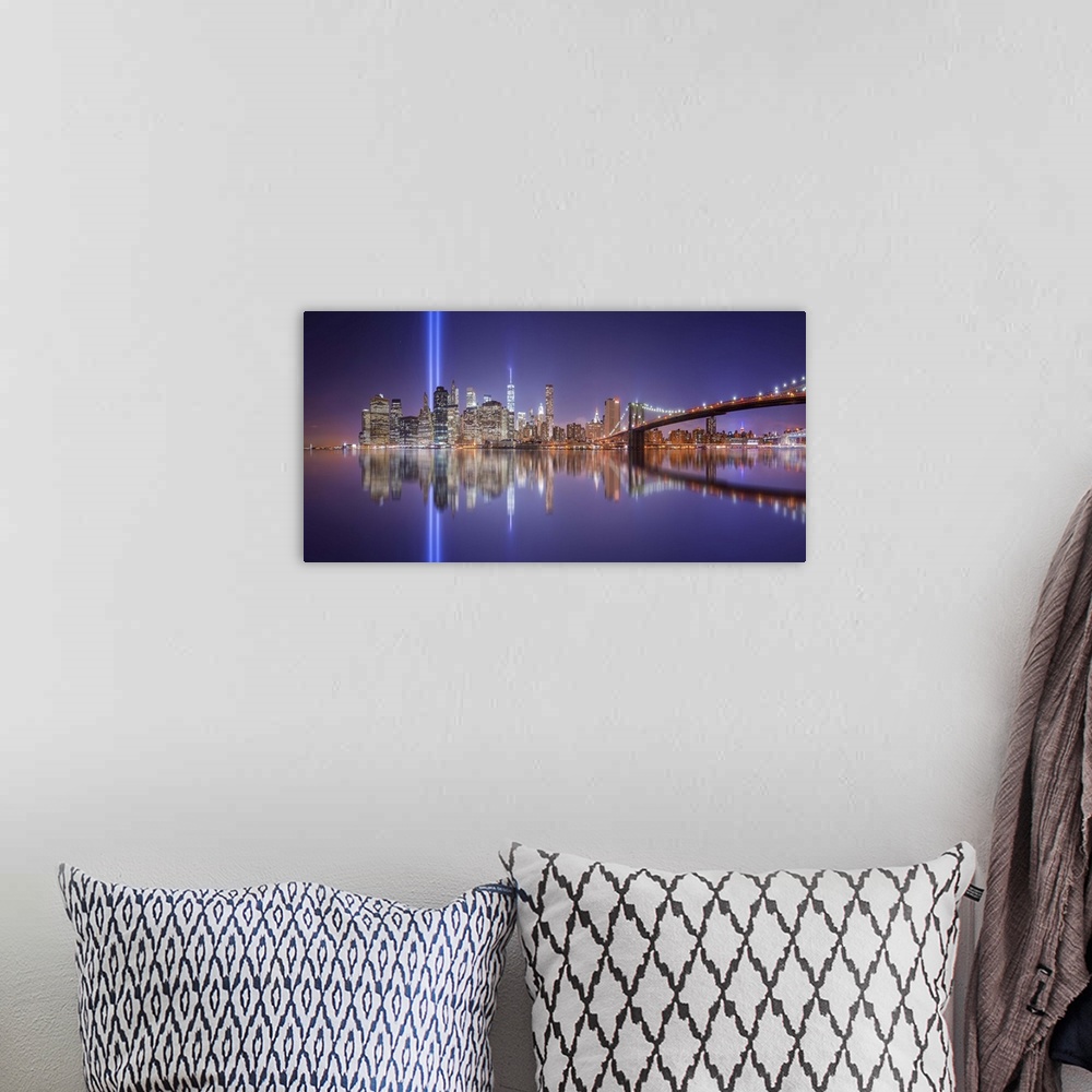 A bohemian room featuring A dynamic photograph of the NYC skyline with the Twin Towers memorial lights shining brightly.