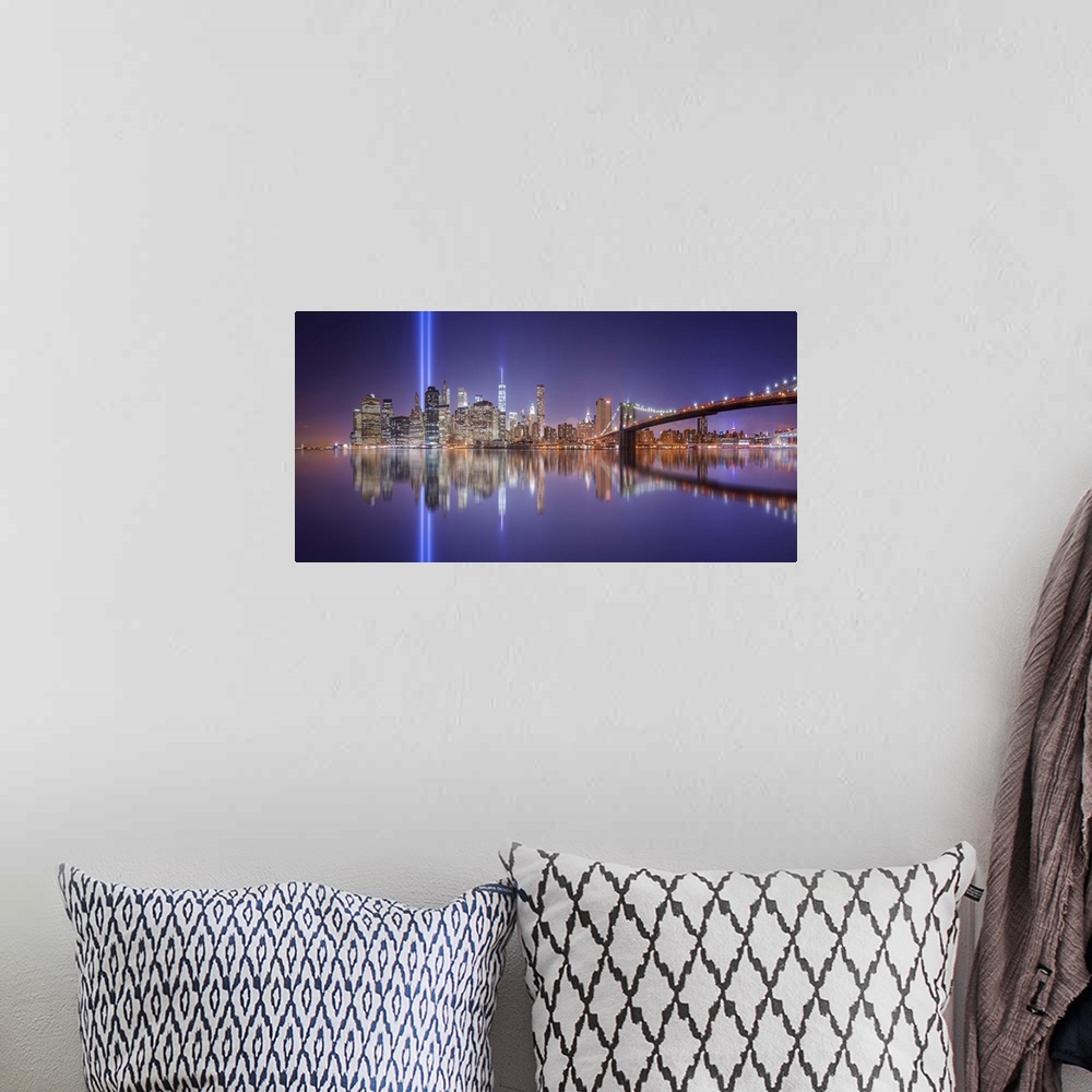 A bohemian room featuring A dynamic photograph of the NYC skyline with the Twin Towers memorial lights shining brightly.