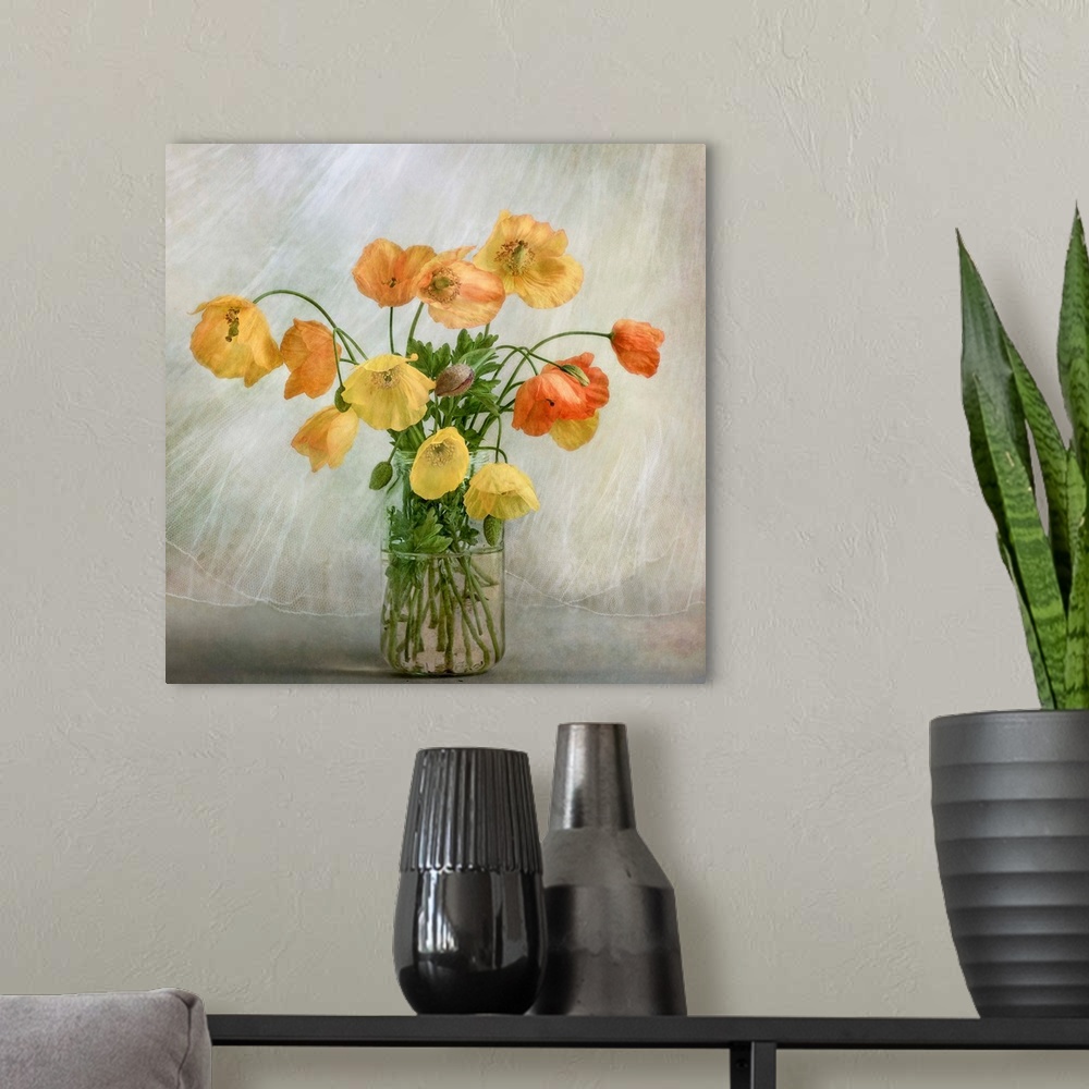 A modern room featuring A glass jar full of yellow and orange poppies.