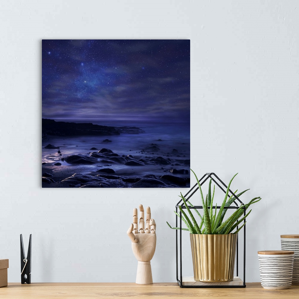 A bohemian room featuring Rocky shoreline under a beautiful starry sky.