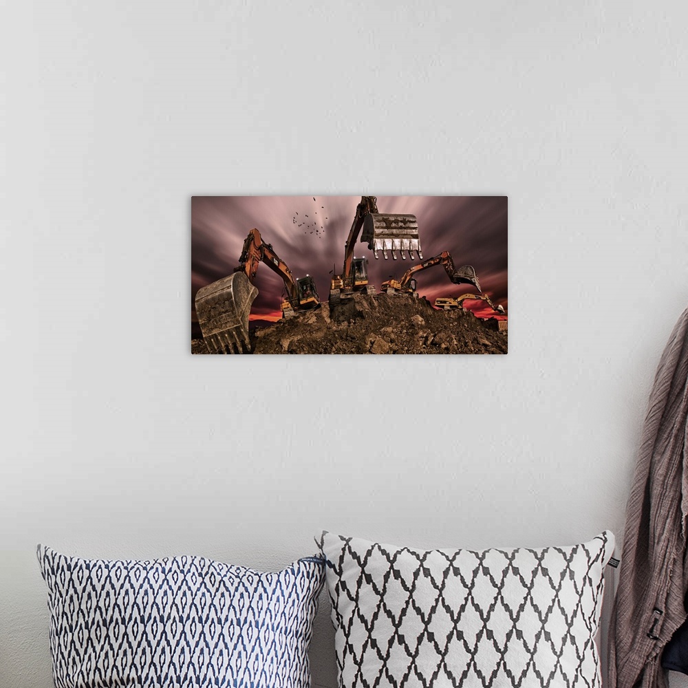 A bohemian room featuring Four excavators digging in a pile of dirt, with a cloudy sky above.