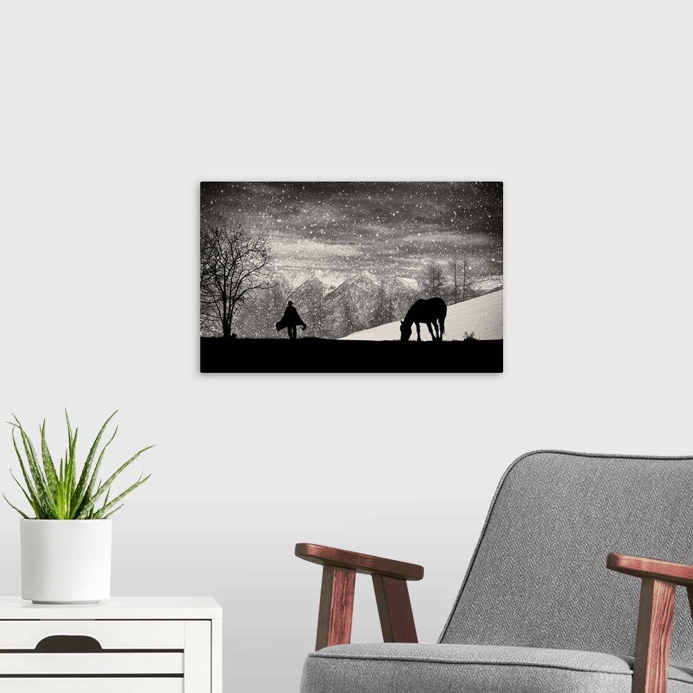 A modern room featuring A silhouette of a grazing horse with a figure walking toward it in the falling snow.