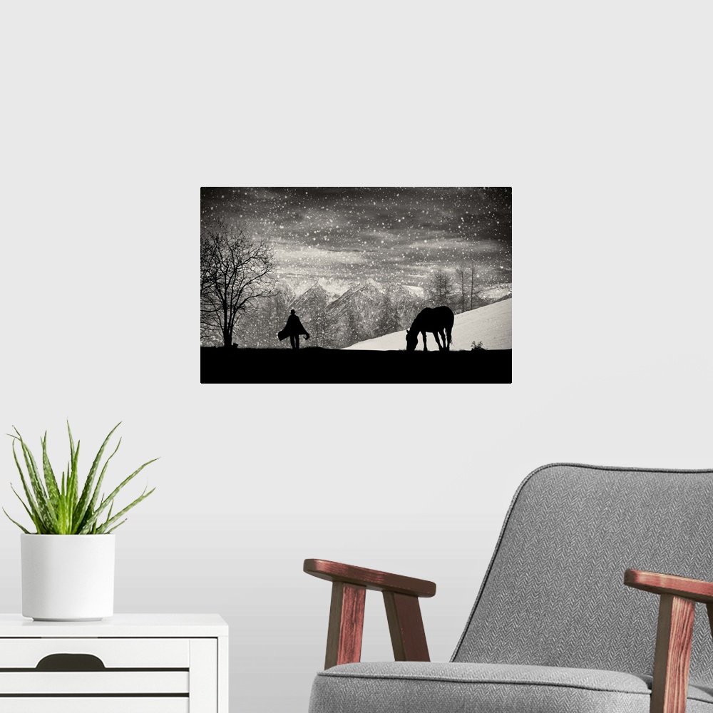 A modern room featuring A silhouette of a grazing horse with a figure walking toward it in the falling snow.