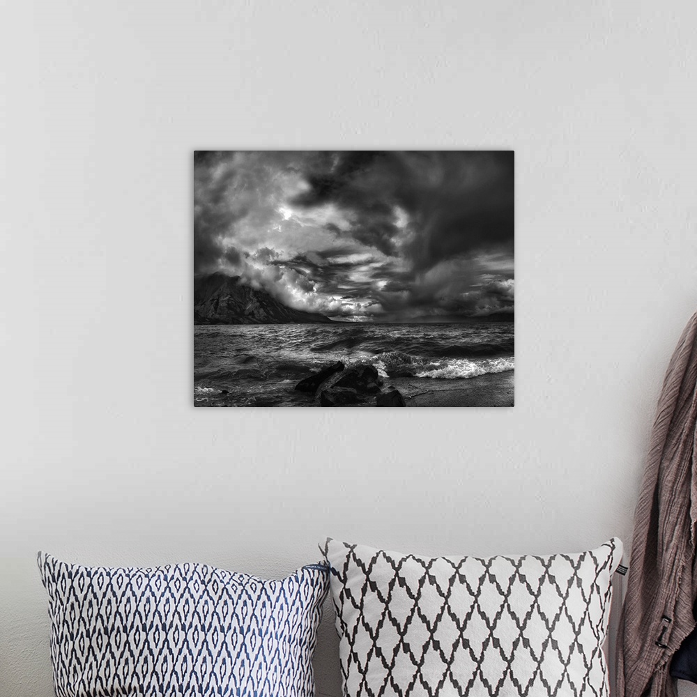 A bohemian room featuring A seascape under a blanket of aggressive looking clouds.