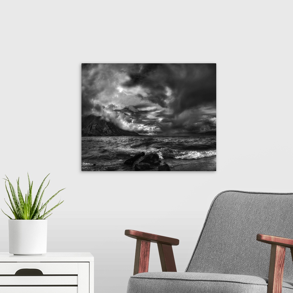 A modern room featuring A seascape under a blanket of aggressive looking clouds.