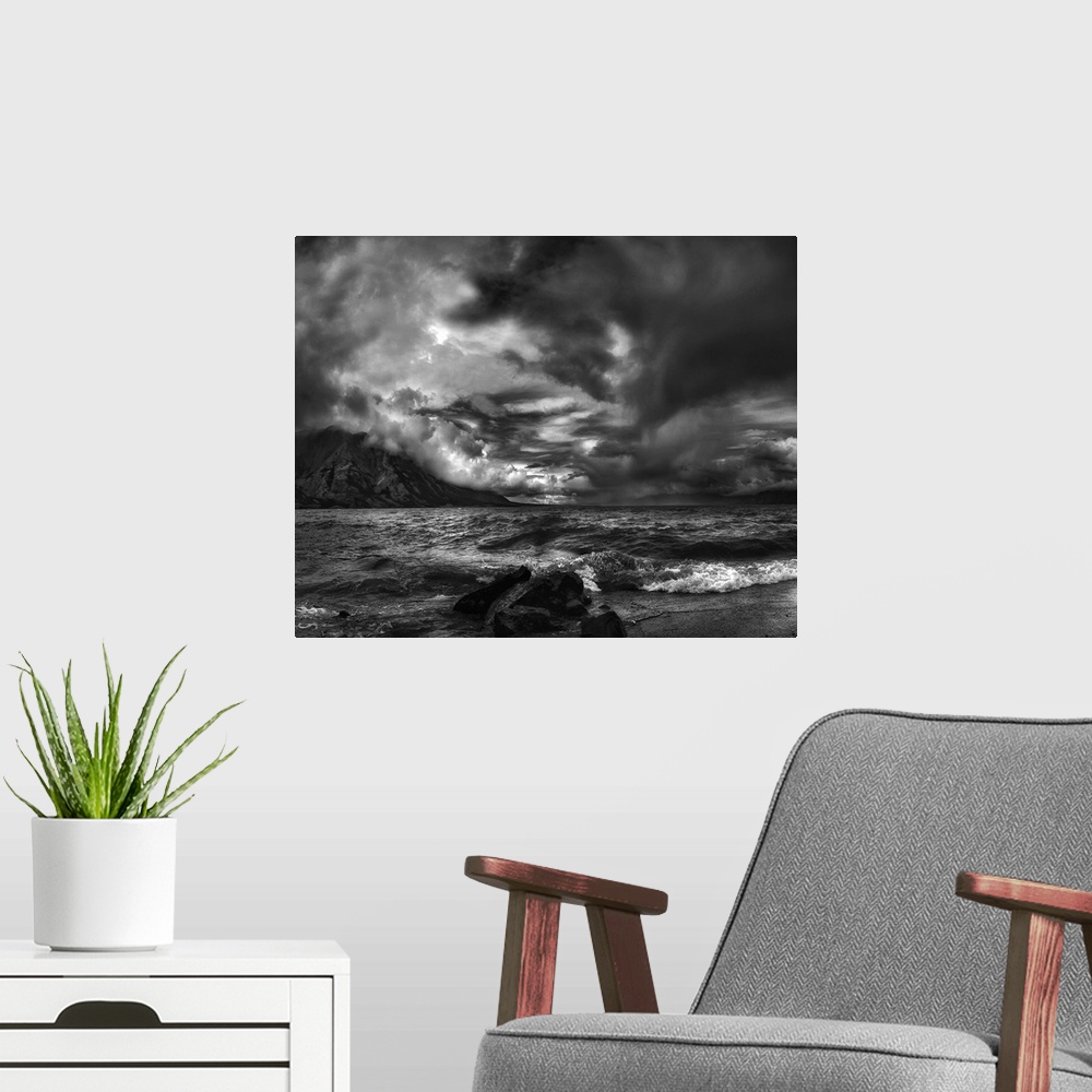 A modern room featuring A seascape under a blanket of aggressive looking clouds.
