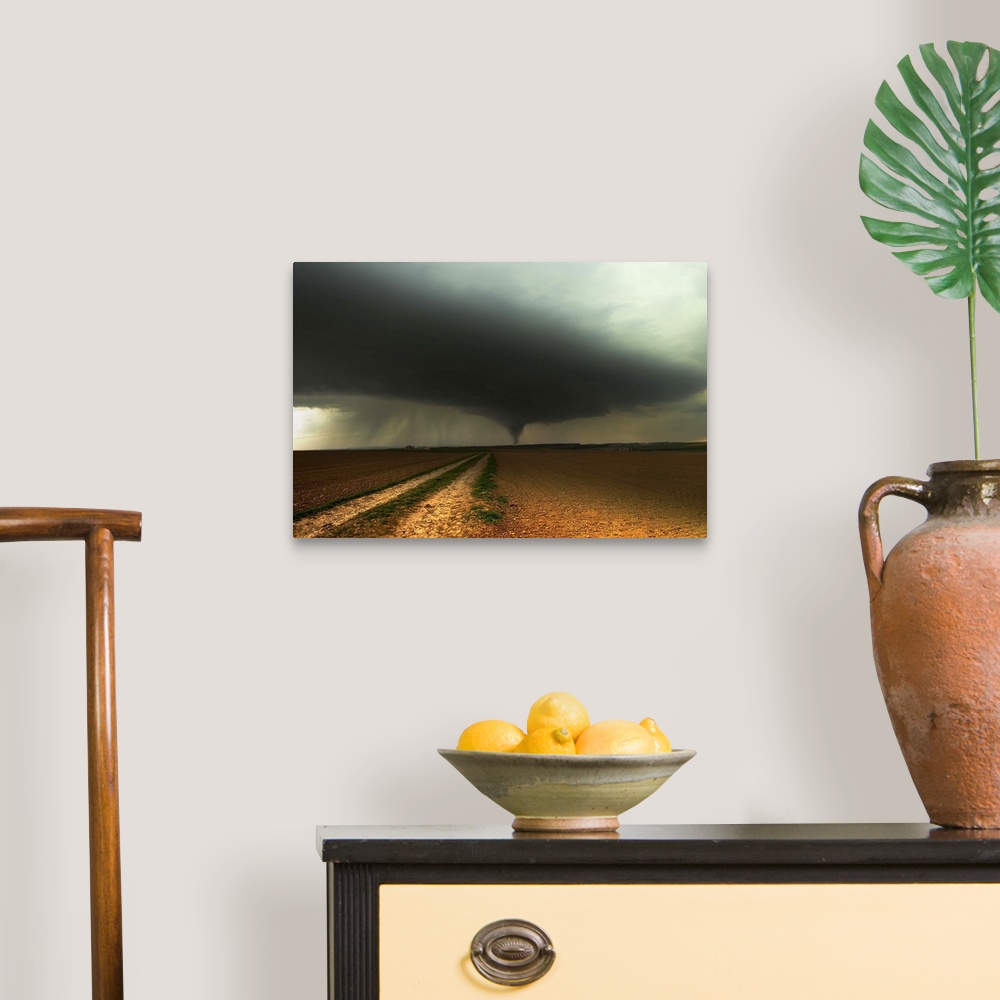 A traditional room featuring A tornado extends into the horizon from storm-clouds overhead, seen from across farmland.