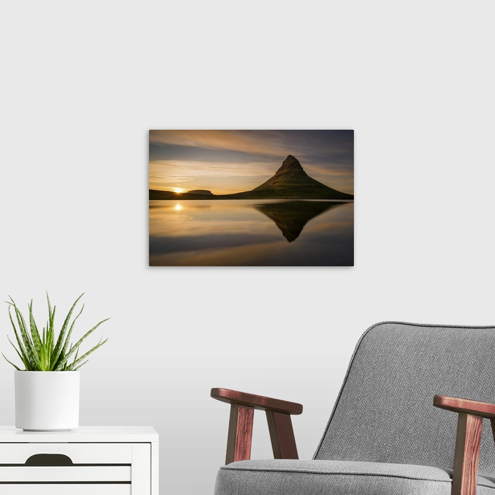 A modern room featuring Kirkjufell mountain at sunrise, reflected in the calm water below, Iceland.