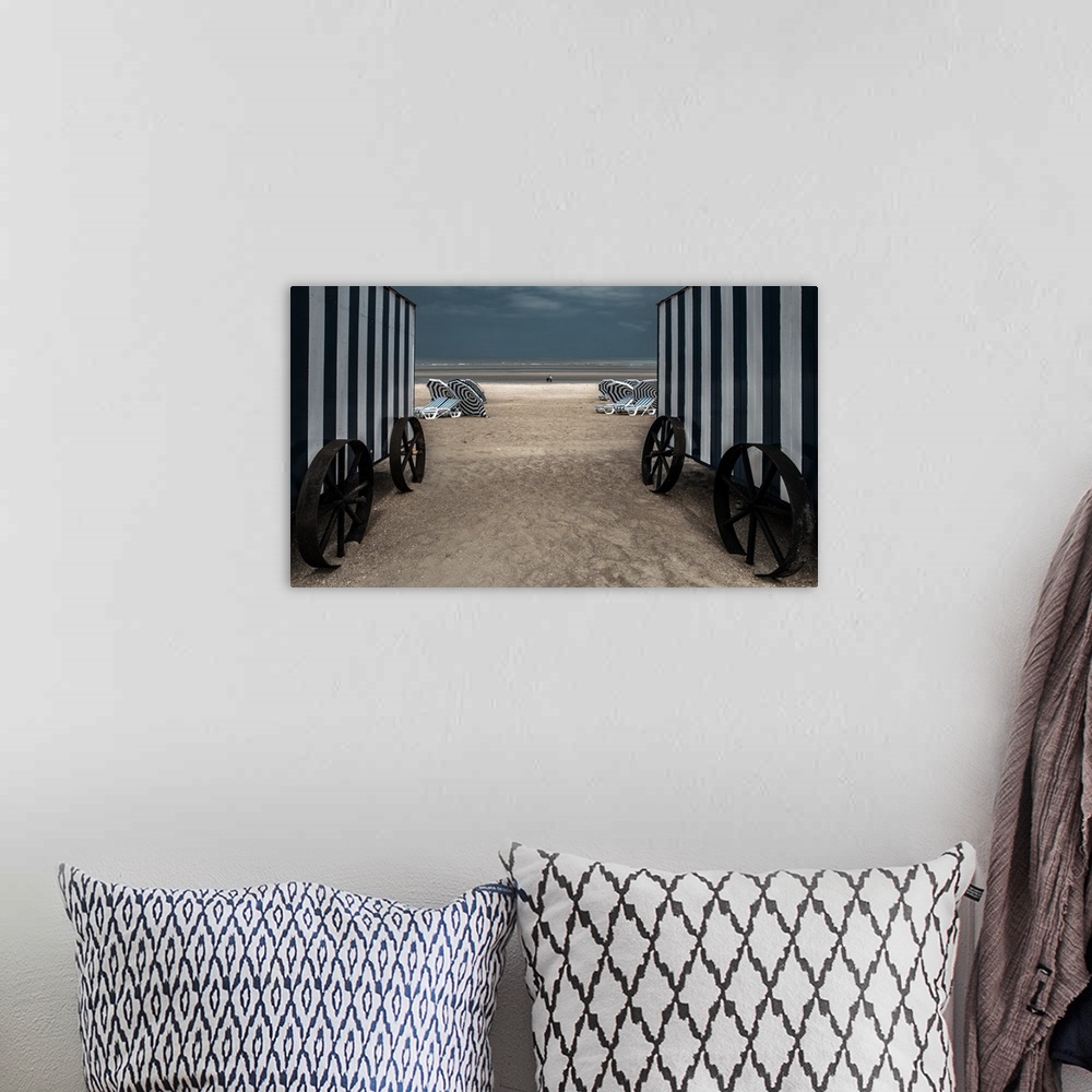 A bohemian room featuring Looking through two beach changing huts down to the beach.