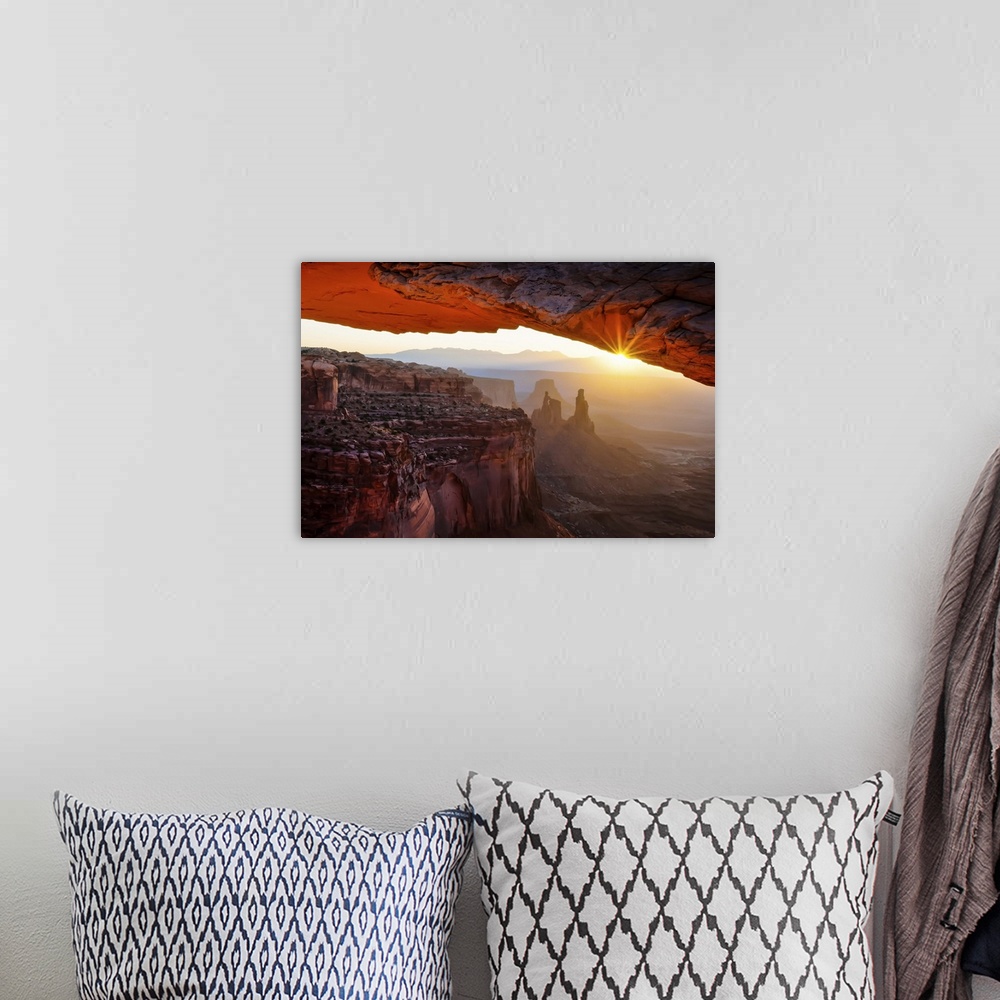 A bohemian room featuring A breathtaking photograph throug the Mesa Arch in Utah's Canyonlands National Park.