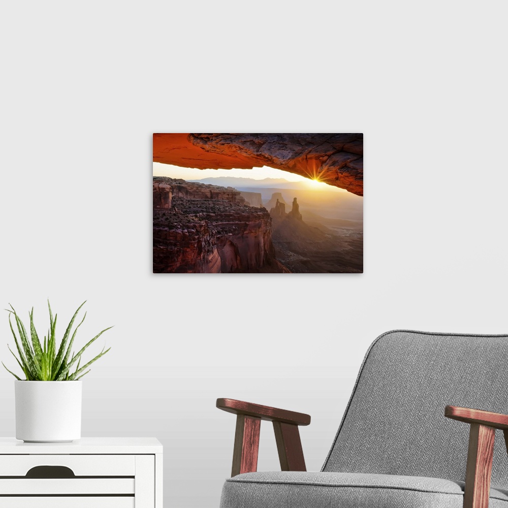 A modern room featuring A breathtaking photograph throug the Mesa Arch in Utah's Canyonlands National Park.