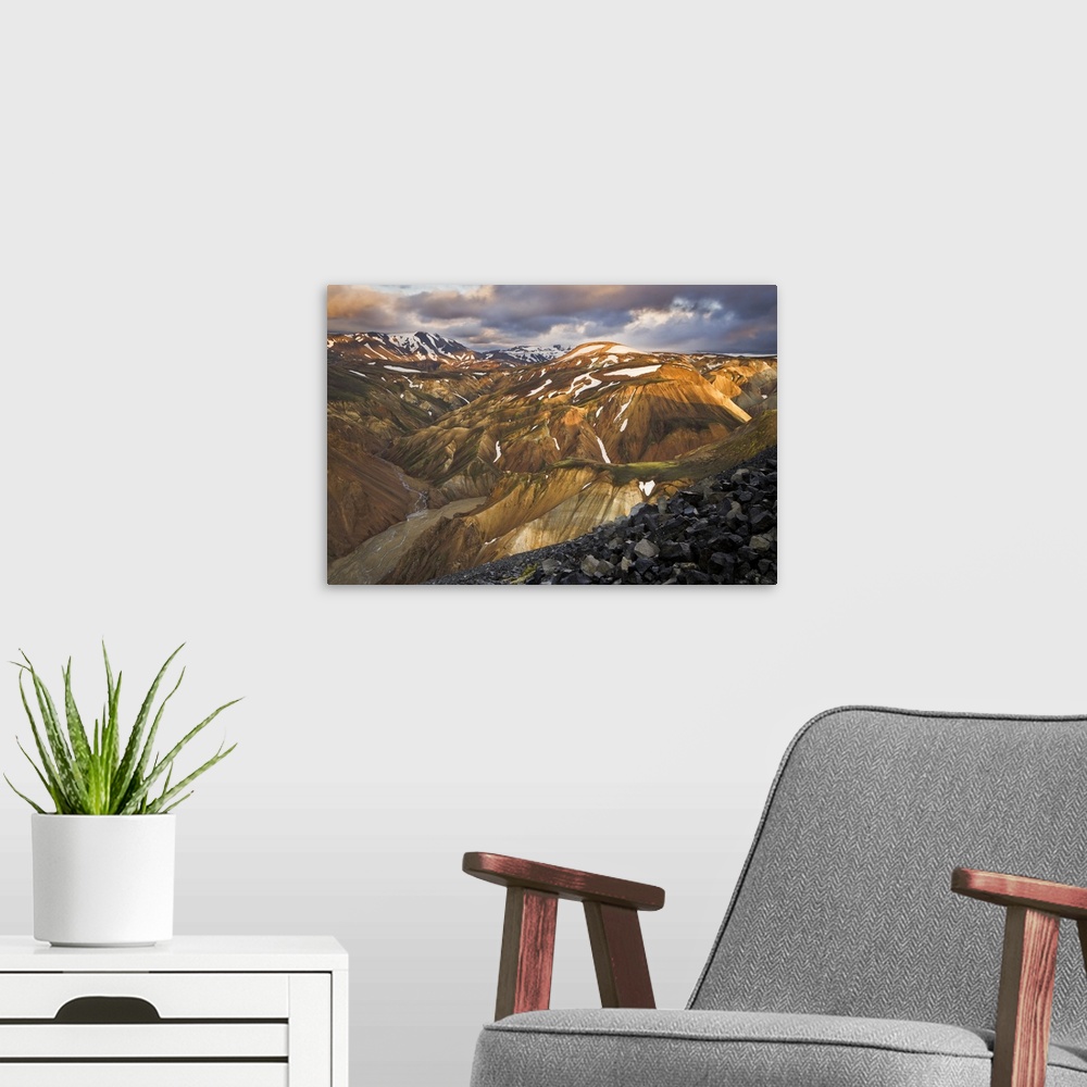 A modern room featuring Mountain range with snow, lit up at sunset, Iceland.