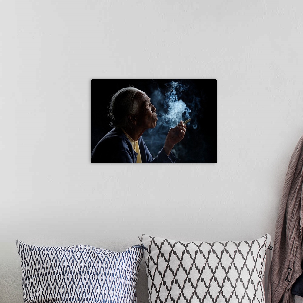 A bohemian room featuring A profile portrait of an old woman with smoke pouring from her mouth.
