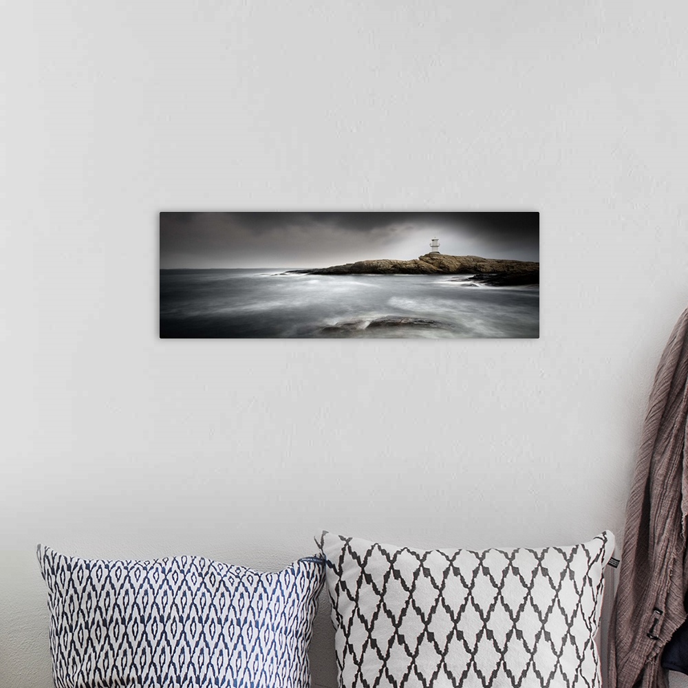 A bohemian room featuring Low tide by a rocky shore with a lighthouse in the distance.