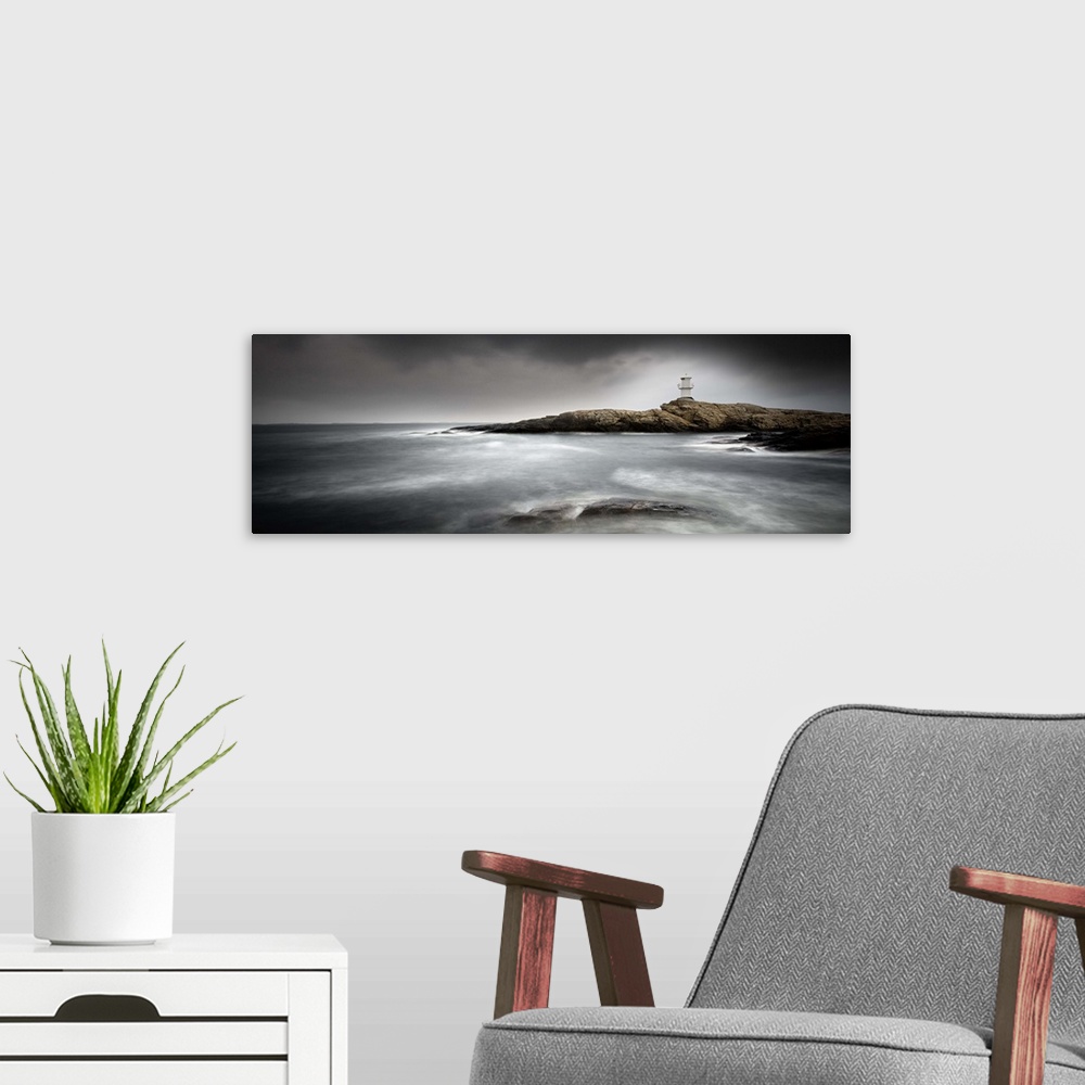A modern room featuring Low tide by a rocky shore with a lighthouse in the distance.