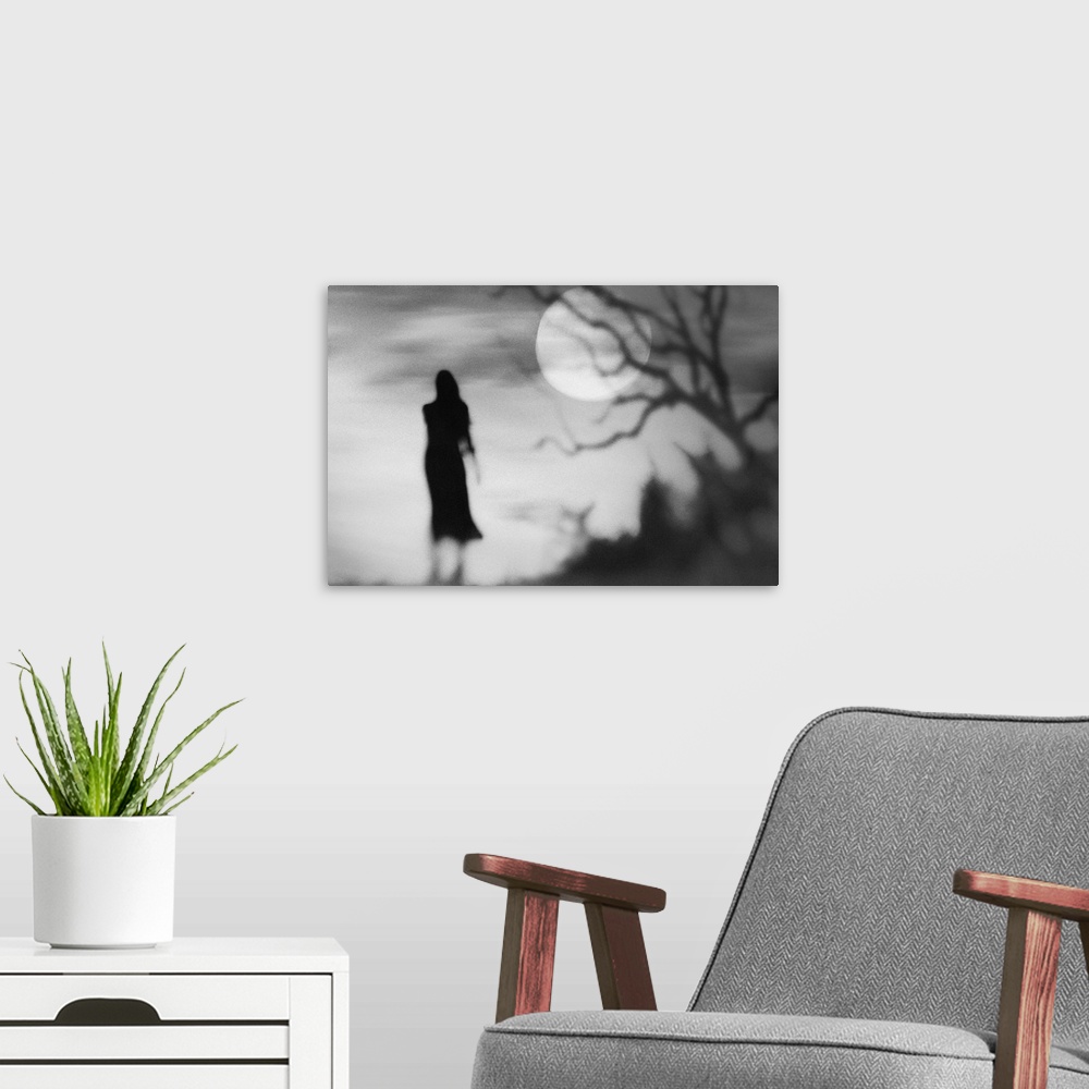 A modern room featuring Eerie conceptual photograph of a silhouetted woman against a background with a full moon.