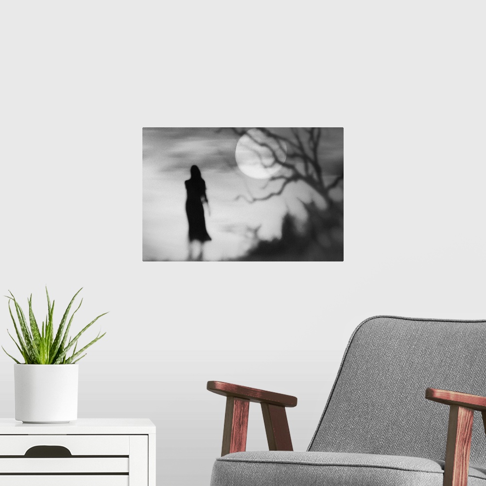 A modern room featuring Eerie conceptual photograph of a silhouetted woman against a background with a full moon.