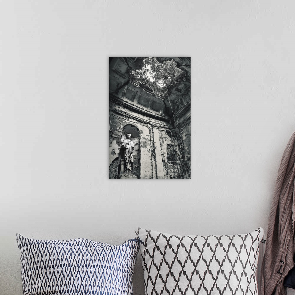 A bohemian room featuring Blue toned black and white photograph of the interior of an old building highlighting a statue, a...