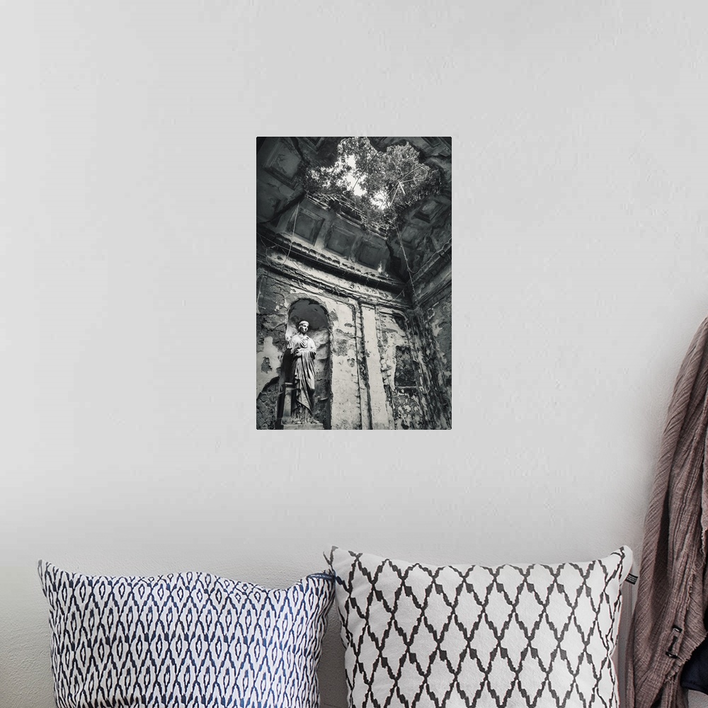 A bohemian room featuring Blue toned black and white photograph of the interior of an old building highlighting a statue, a...