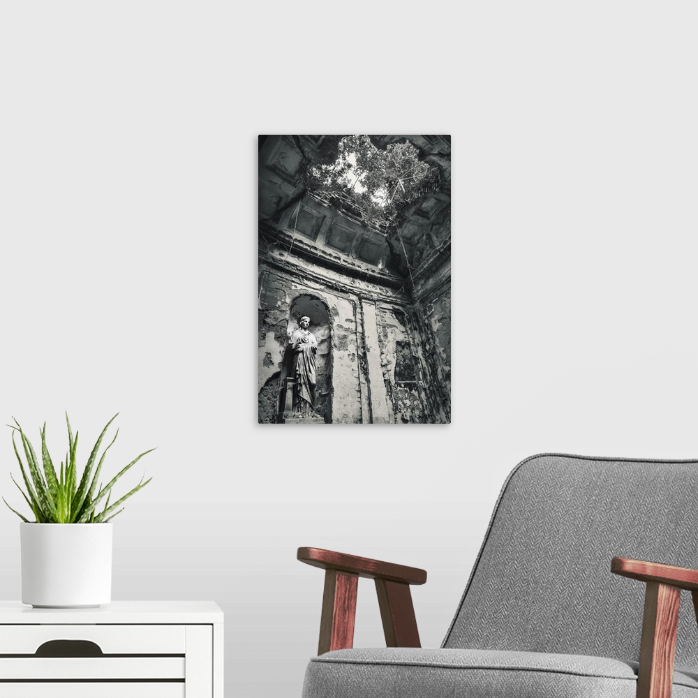 A modern room featuring Blue toned black and white photograph of the interior of an old building highlighting a statue, a...