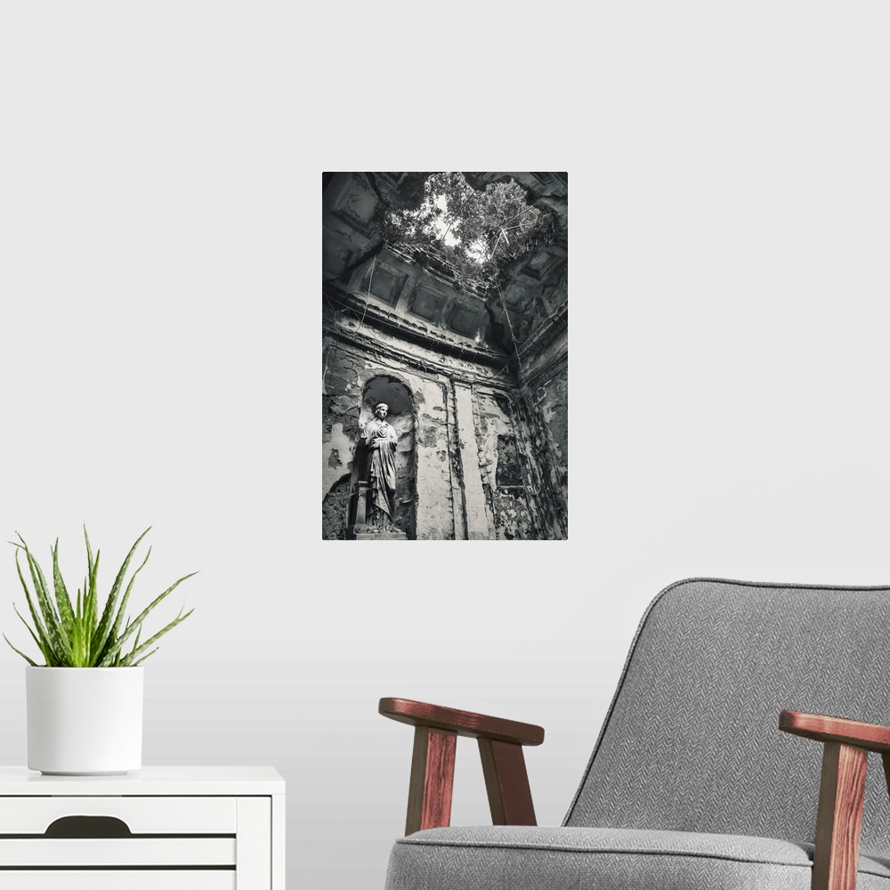 A modern room featuring Blue toned black and white photograph of the interior of an old building highlighting a statue, a...