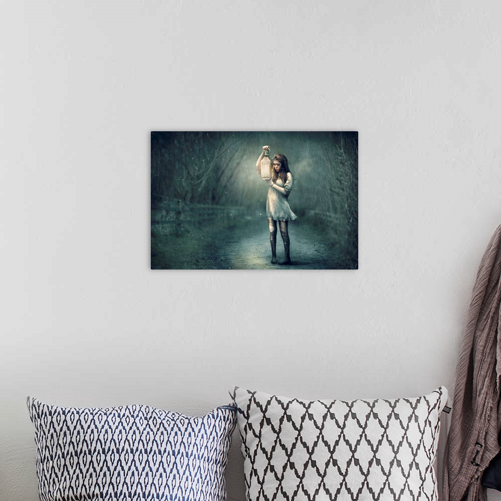 A bohemian room featuring A conceptual photograph of woman in tattered clothing holding a lantern in the rain.
