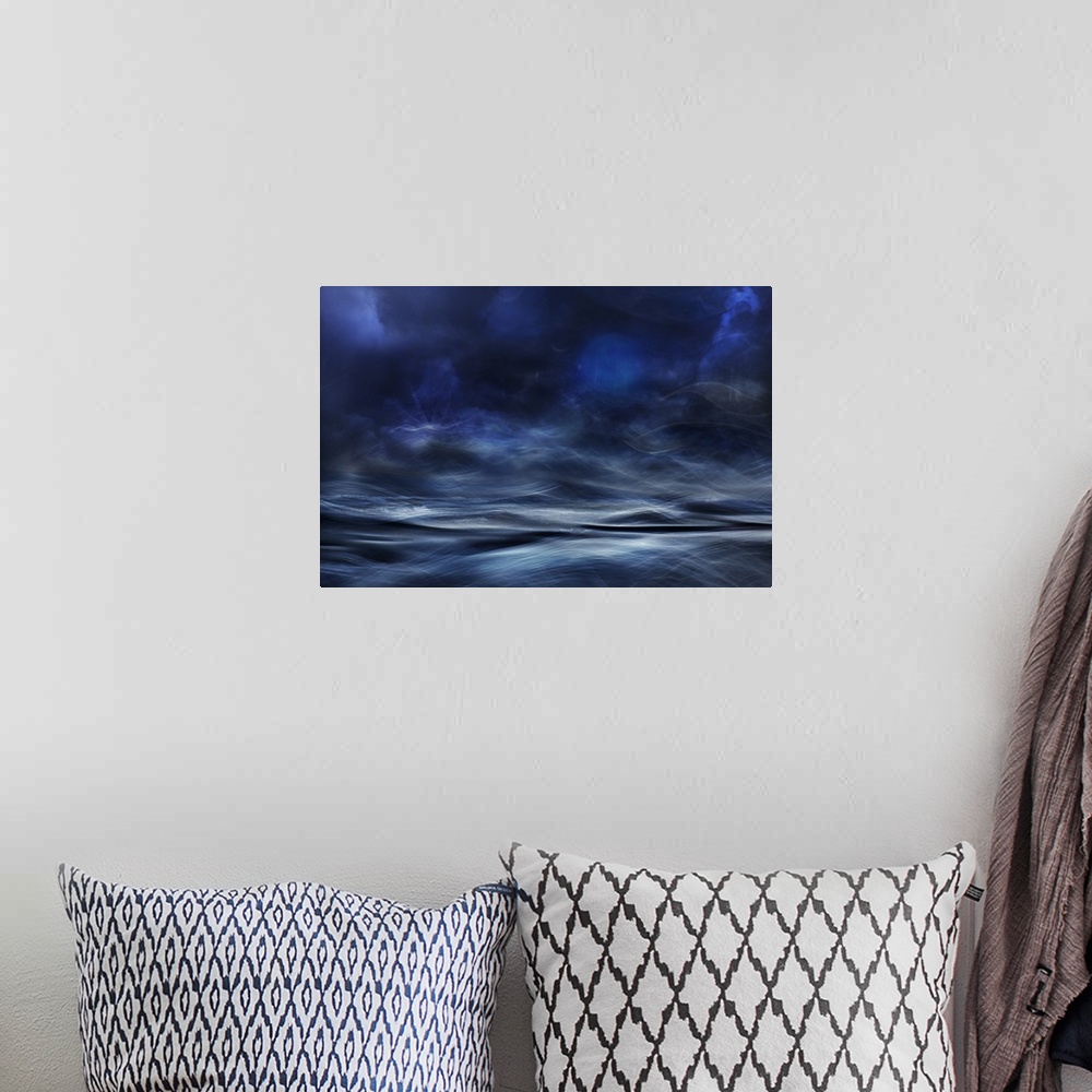 A bohemian room featuring Abstract digital art with blue, white and black hues resembling a waterscape.