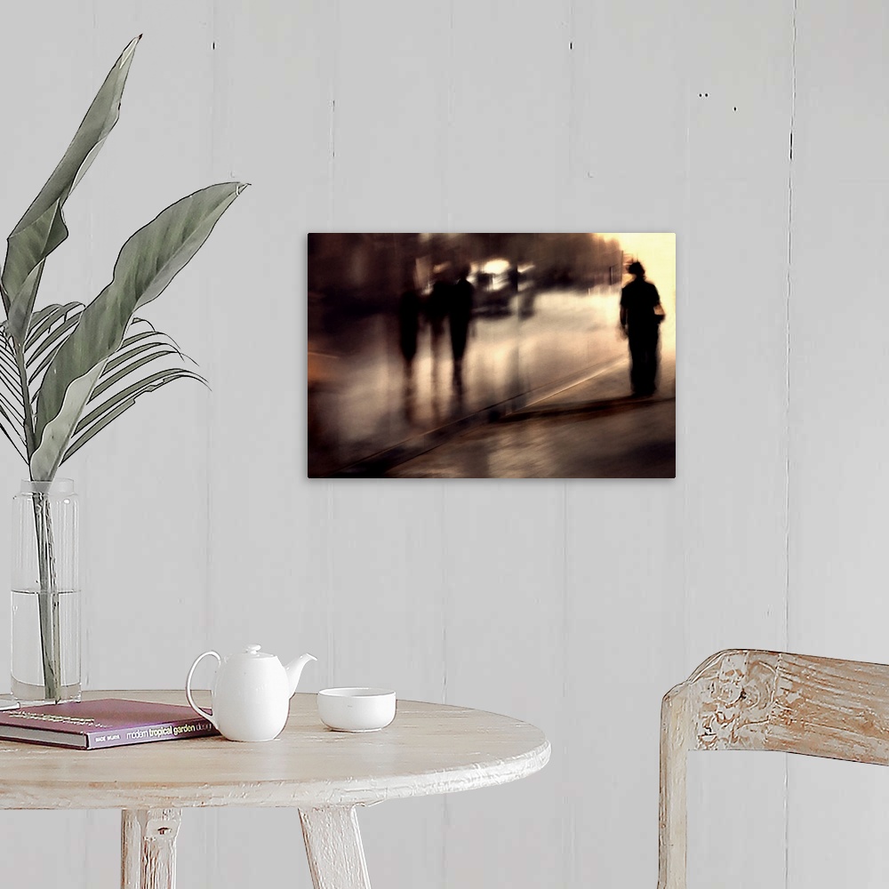 A farmhouse room featuring Photo of people walking in a city street with motion blur, making them resemble shadows.