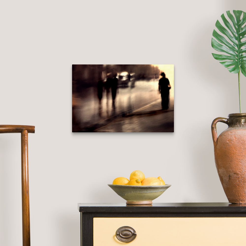 A traditional room featuring Photo of people walking in a city street with motion blur, making them resemble shadows.