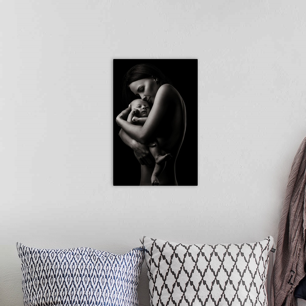 A bohemian room featuring A fine art photograph of a woman holding her infant child lovingly.